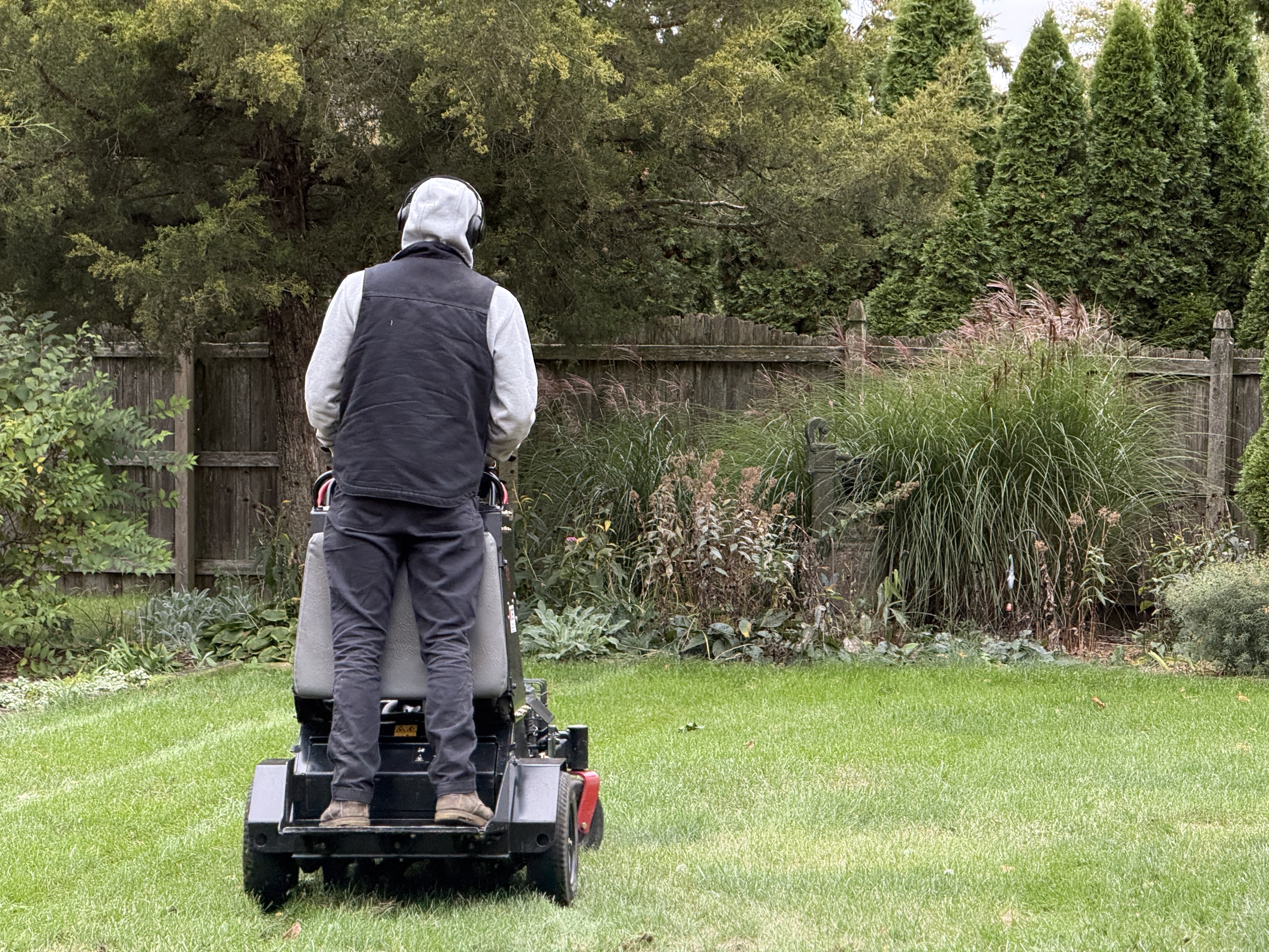Core aeration being performed on a lawn